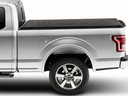 Side profile of a truck with an extended tonneau cover.